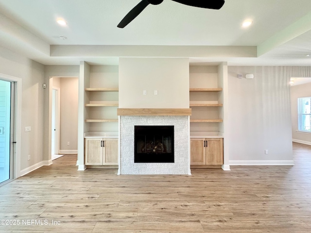 44 Vega Ct, Saint Augustine, FL 32095 - unfurnished living room with a ceiling fan, a fireplace, built in shelves, baseboards, and light wood-style floors
