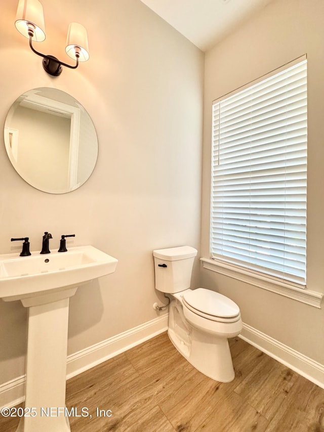 44 Vega Ct, Saint Augustine, FL 32095 - half bathroom with toilet, baseboards, a sink, and wood finished floors