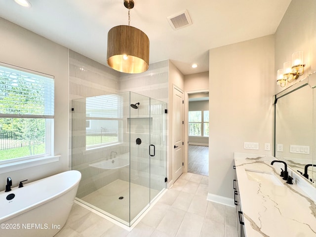 44 Vega Ct, Saint Augustine, FL 32095 - bathroom featuring visible vents, a freestanding tub, a stall shower, vanity, and baseboards