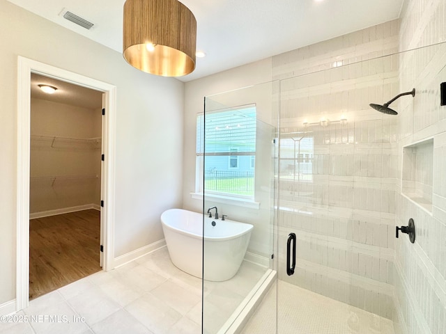 44 Vega Ct, Saint Augustine, FL 32095 - bathroom featuring a freestanding tub, a stall shower, a spacious closet, and visible vents