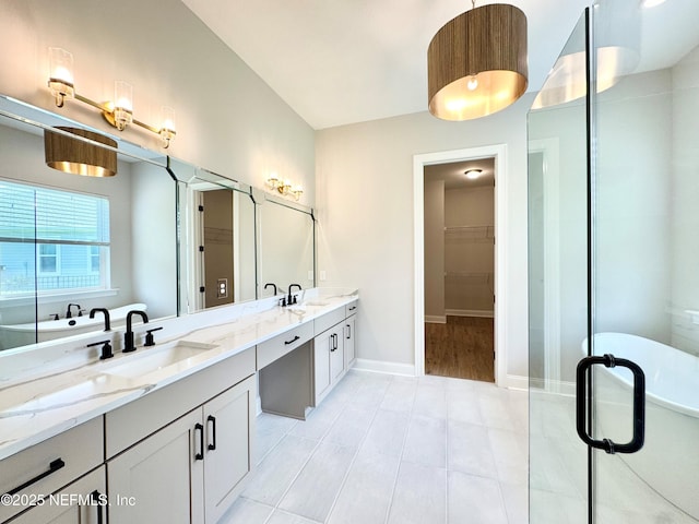 44 Vega Ct, Saint Augustine, FL 32095 - bathroom featuring a sink, baseboards, double vanity, and a spacious closet