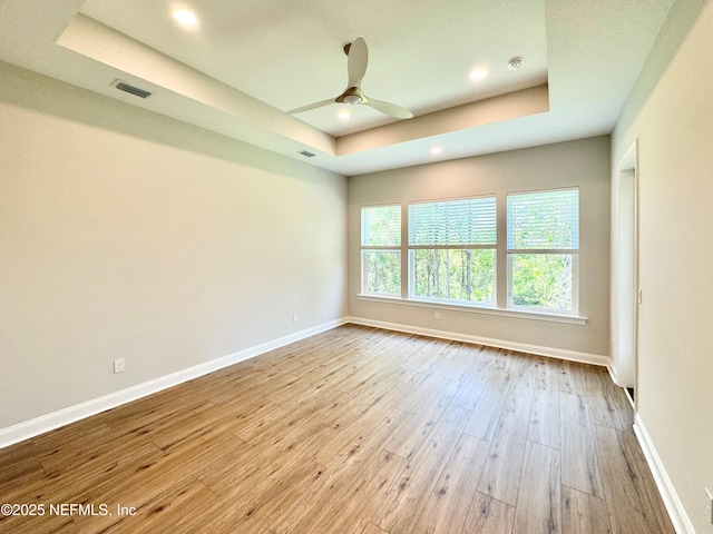 44 Vega Ct, Saint Augustine, FL 32095 - empty room with a ceiling fan, visible vents, hardwood / wood-style flooring, baseboards, and a tray ceiling