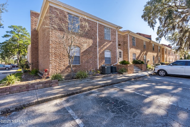 view of side of home with central AC