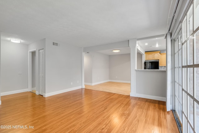 unfurnished living room with light hardwood / wood-style floors