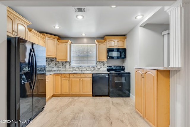 kitchen with black appliances, light brown cabinets, and sink