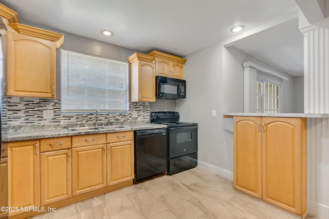 kitchen featuring black appliances, decorative backsplash, sink, and light brown cabinetry