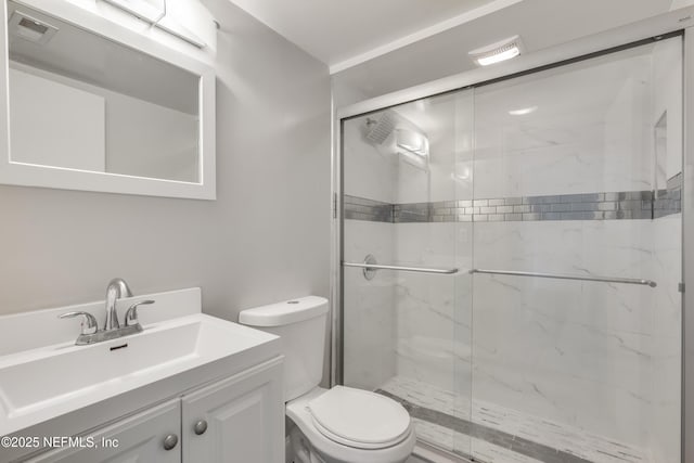 bathroom featuring vanity, toilet, and an enclosed shower