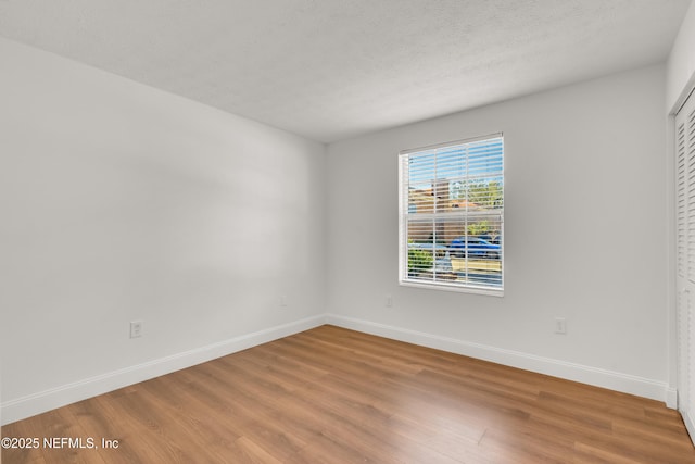 unfurnished room featuring hardwood / wood-style floors