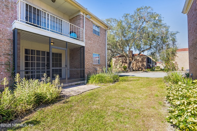 view of yard featuring a balcony