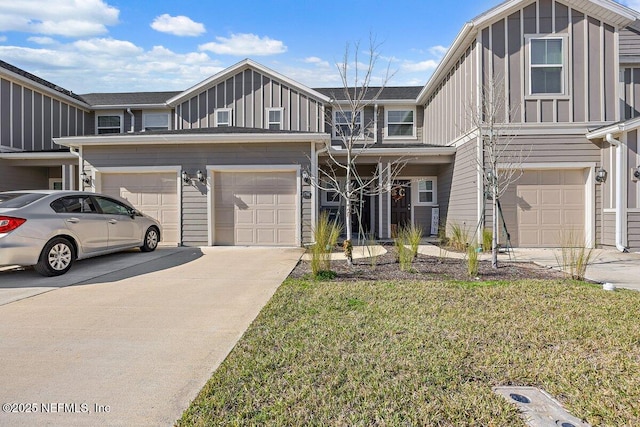 view of property featuring a front lawn and a garage