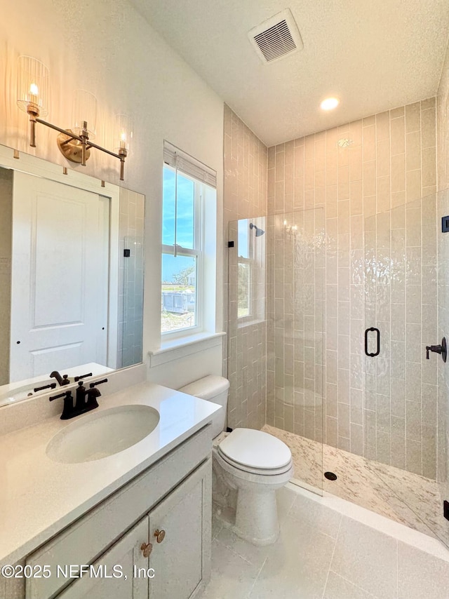 269 Pasarela Dr, Saint Augustine, FL 32095 - bathroom with tile patterned flooring, vanity, toilet, visible vents, and a stall shower