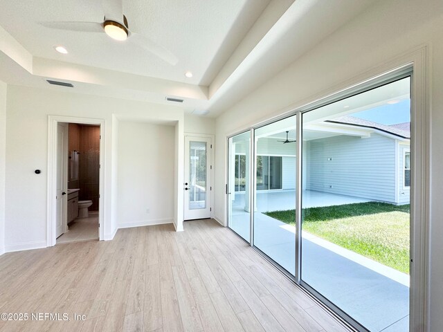 269 Pasarela Dr, Saint Augustine, FL 32095 - interior space featuring ceiling fan, a tray ceiling, and light wood-type flooring