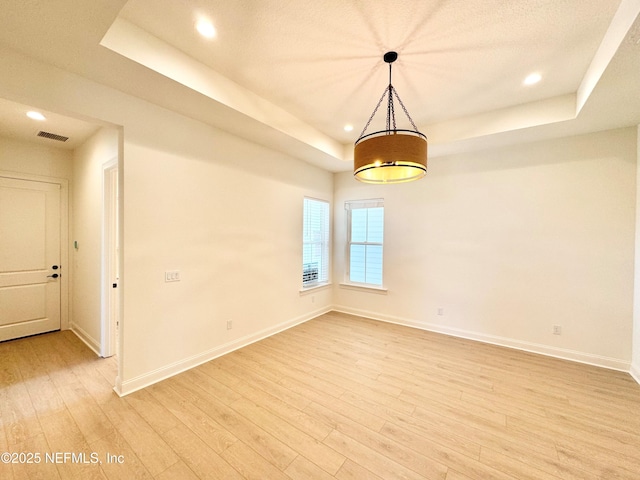 269 Pasarela Dr, Saint Augustine, FL 32095 - unfurnished room featuring visible vents, light wood-style flooring, a raised ceiling, and baseboards