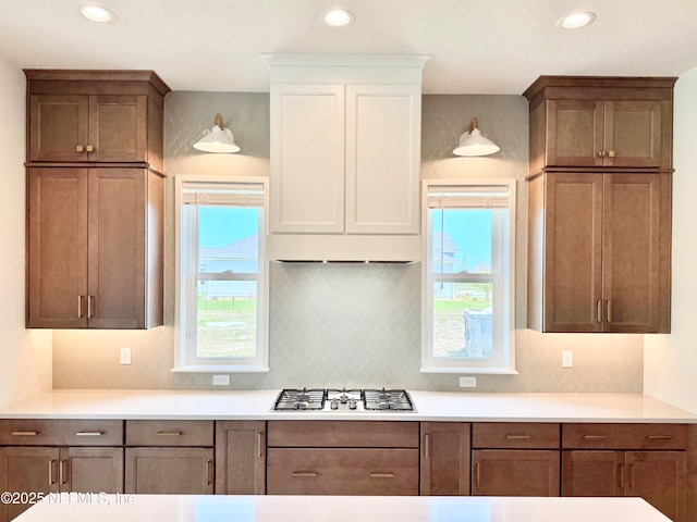 269 Pasarela Dr, Saint Augustine, FL 32095 - kitchen featuring light countertops, decorative backsplash, white cabinets, and stainless steel gas stovetop