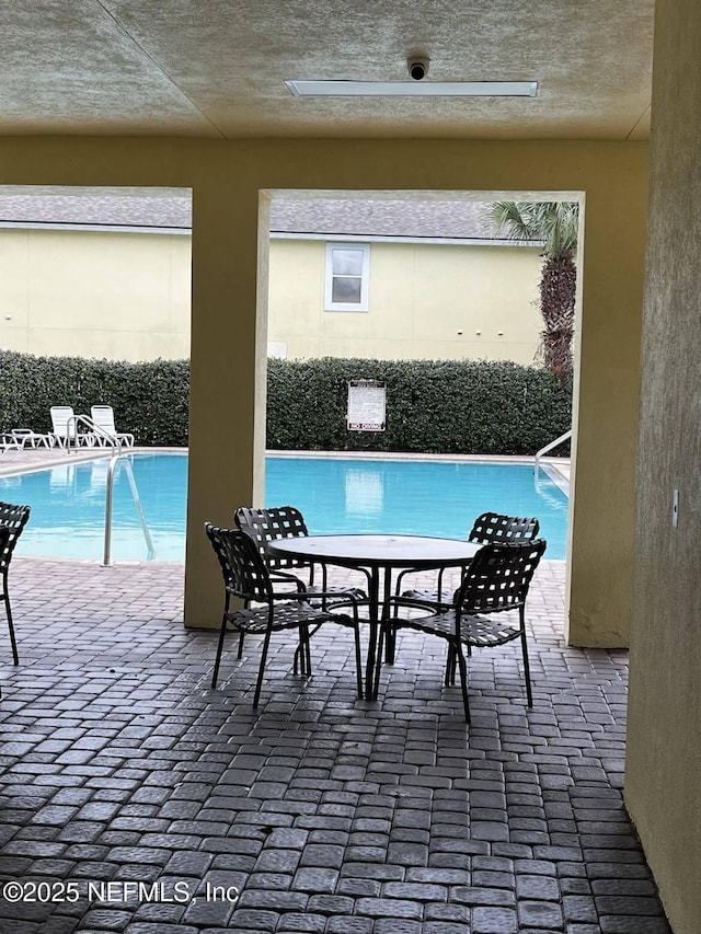 view of pool with a patio area