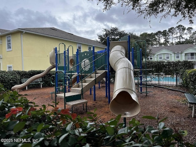 view of playground with a community pool