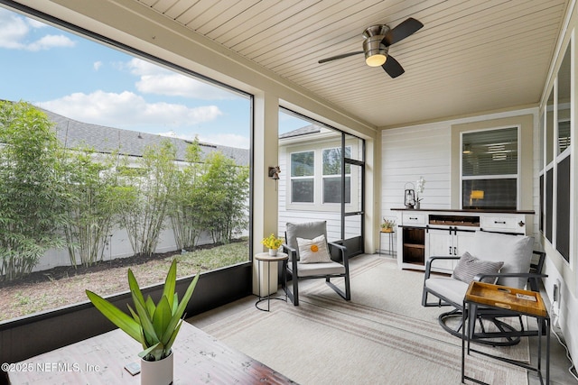 sunroom / solarium featuring ceiling fan