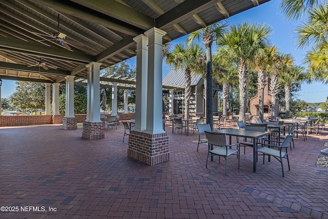 view of patio featuring an outdoor fireplace and ceiling fan