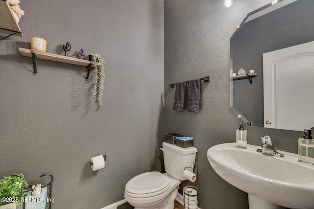 bathroom with toilet and sink