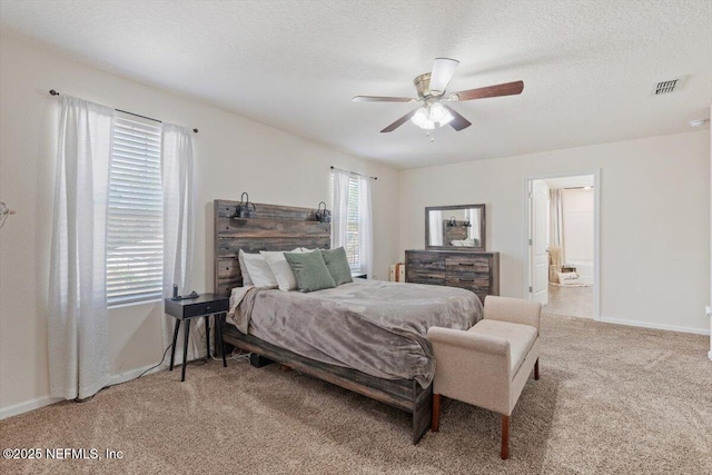 carpeted bedroom with ceiling fan and a textured ceiling