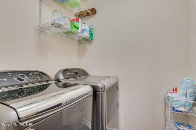 laundry room featuring washing machine and clothes dryer