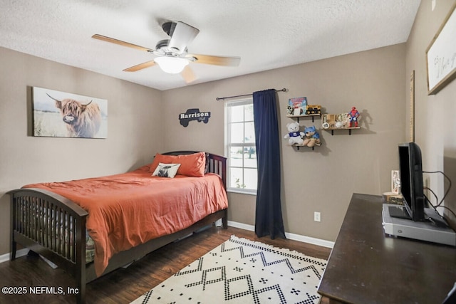 bedroom featuring ceiling fan, dark hardwood / wood-style flooring, and a textured ceiling