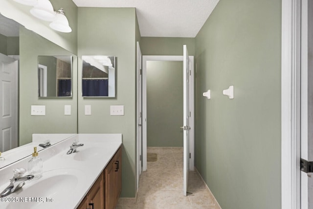 bathroom featuring tile patterned flooring, a textured ceiling, and vanity