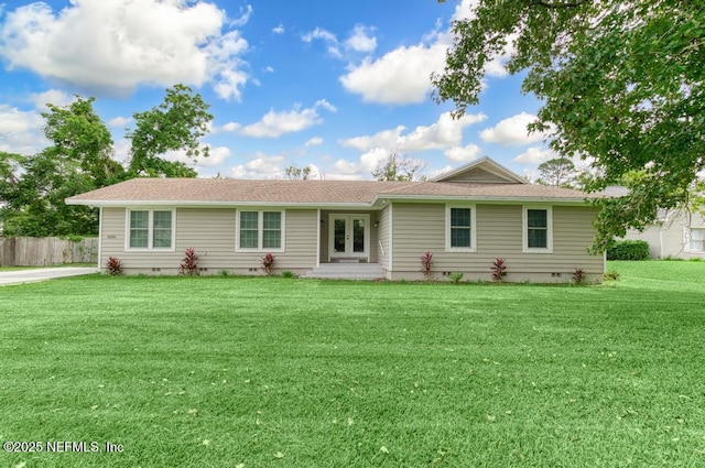 rear view of house with a yard and french doors