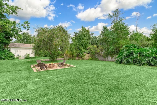 view of yard with a fire pit