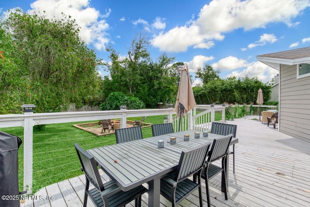 wooden deck with a lawn