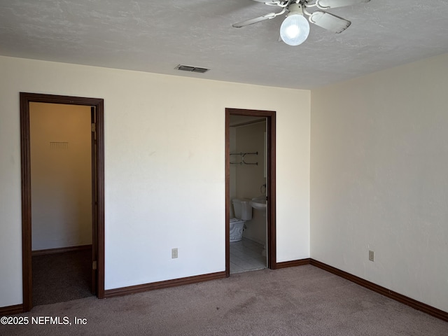 unfurnished bedroom featuring visible vents, baseboards, carpet, and a textured ceiling