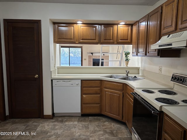 kitchen featuring electric range, a sink, light countertops, under cabinet range hood, and dishwasher