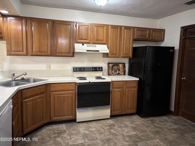 kitchen featuring white dishwasher, freestanding refrigerator, a sink, electric range oven, and under cabinet range hood