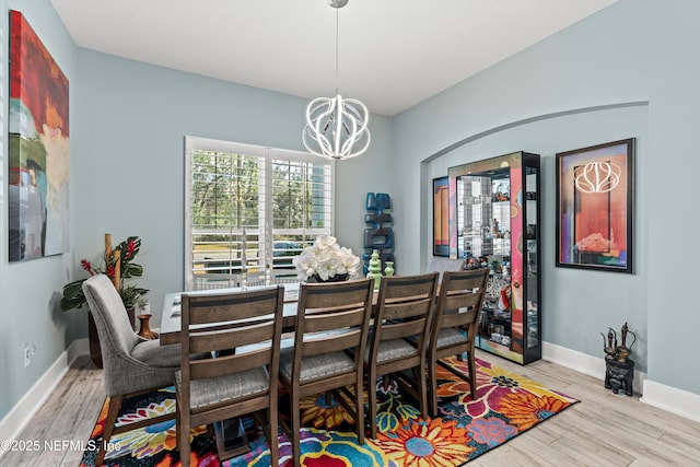 dining room featuring light hardwood / wood-style flooring and a notable chandelier