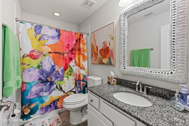 bathroom featuring vanity, a shower with curtain, a textured ceiling, and toilet