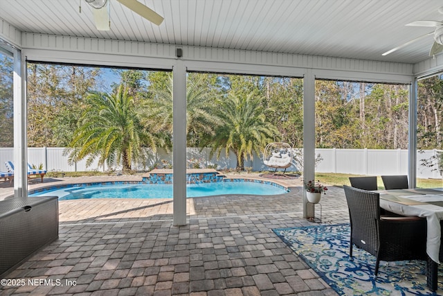 view of swimming pool with pool water feature, ceiling fan, and a patio area