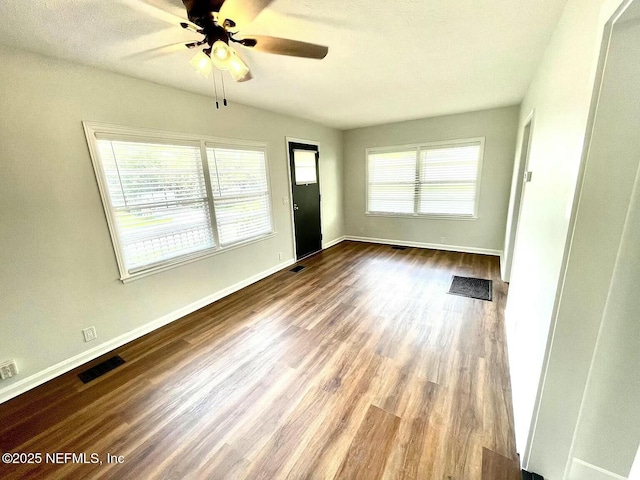 empty room with ceiling fan and wood-type flooring