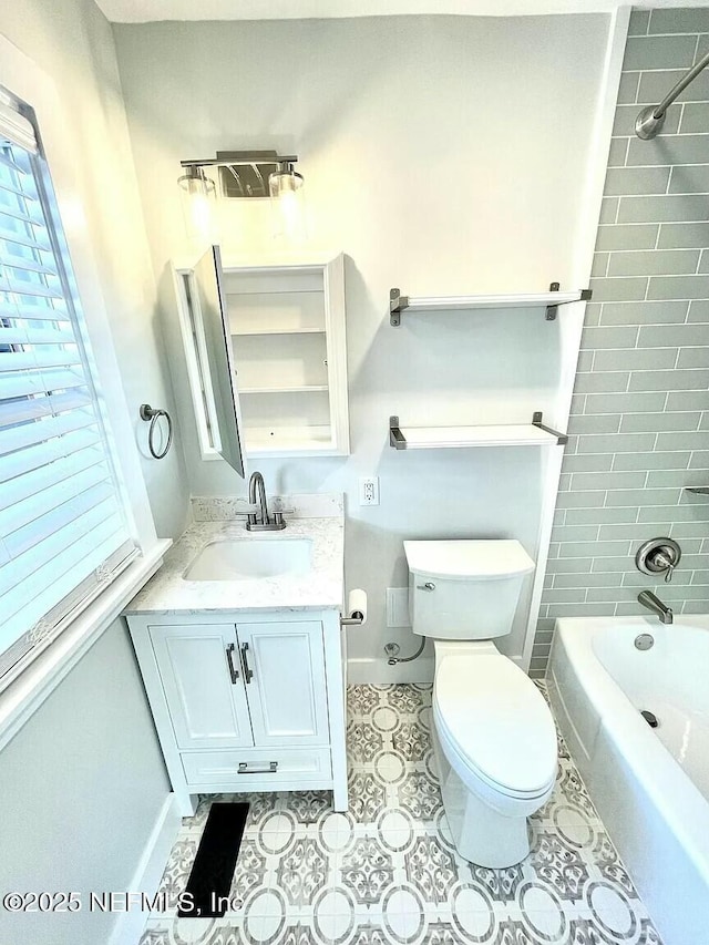 full bathroom featuring toilet, vanity, and tiled shower / bath combo