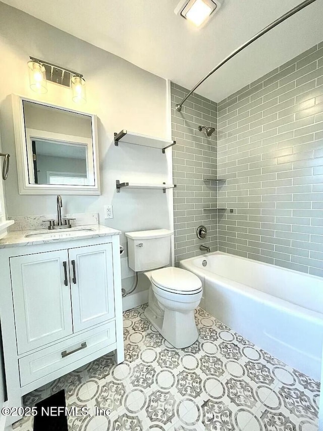 full bathroom with vanity, tiled shower / bath combo, and toilet