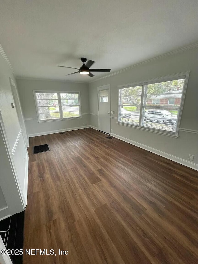 unfurnished living room featuring ceiling fan, dark hardwood / wood-style flooring, and ornamental molding