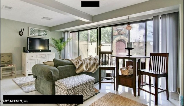 sunroom / solarium featuring beam ceiling