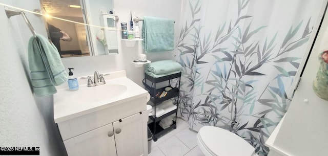 bathroom featuring tile patterned flooring, vanity, toilet, and curtained shower