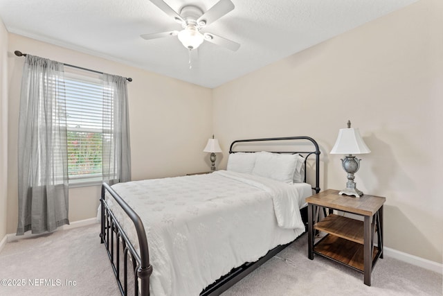 carpeted bedroom featuring ceiling fan and multiple windows