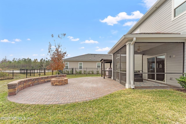 view of yard featuring a fire pit, a sunroom, and a patio area