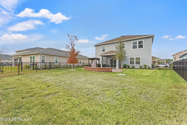 back of property featuring a lawn and a gazebo