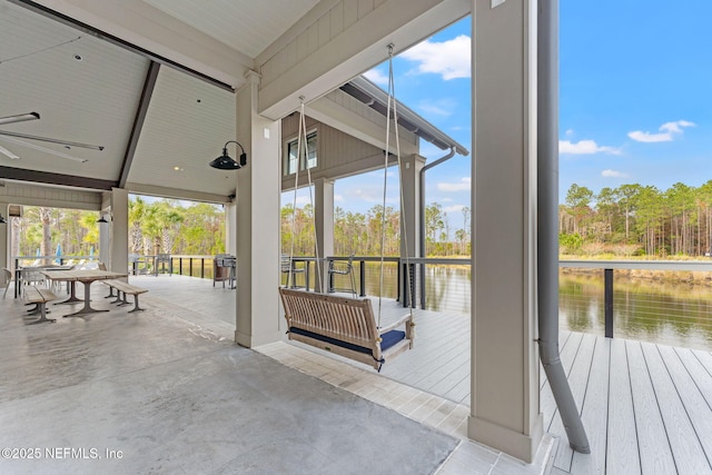 doorway with beam ceiling and a water view