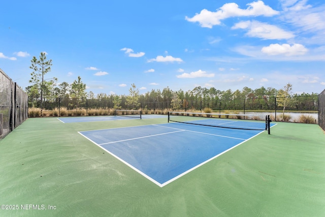 view of tennis court with basketball hoop