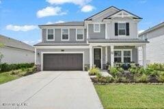 front facade featuring a garage and a front yard