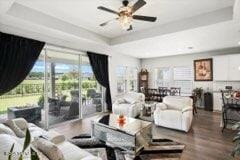 living room with hardwood / wood-style flooring and ceiling fan