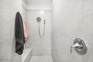 bathroom with a tile shower